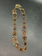 Nice looking gold tone with amber colored stones ladies belt…..adjustable for waist size