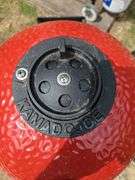 Red Kamado Joe Grill on rollaround iron stand w/cover and some like new accessories...