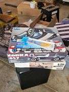 Unopened model airplane, model car, paint brushes and paints