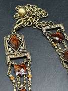 Nice looking gold tone with amber colored stones ladies belt…..adjustable for waist size