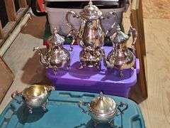 Tub of silver plate items. Two teapots, heated coffee pot, covered sugar, and creamer.