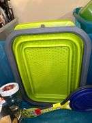 Tote full of miscellaneous household/kitchen items…..2 teal pitchers (acrylic and heavy plastic, collapsible strainer, splatter screen and more