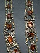 Nice looking gold tone with amber colored stones ladies belt…..adjustable for waist size