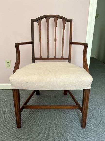 Vintage solid wood (mahogany?) arm chair wood that remnants of original burlap strap seating still visible….22-1/2 x 18-1/2 x 18 tall to seat (36-1/2 tall overall)….seat has staining image