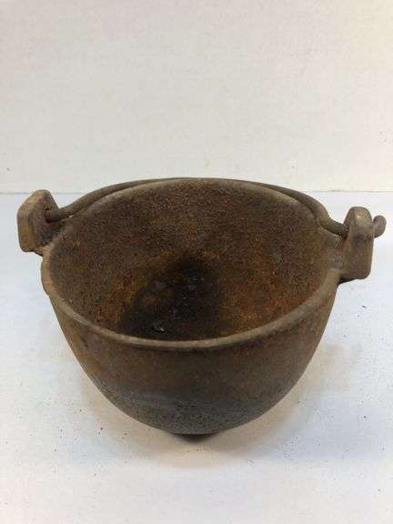 Antique smelting pot. 5” diameter. Plus round block of metal.