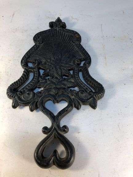 J.Z.H. 1948 cast iron Sunburst trivet. Black. Footed. 9 x 5”
