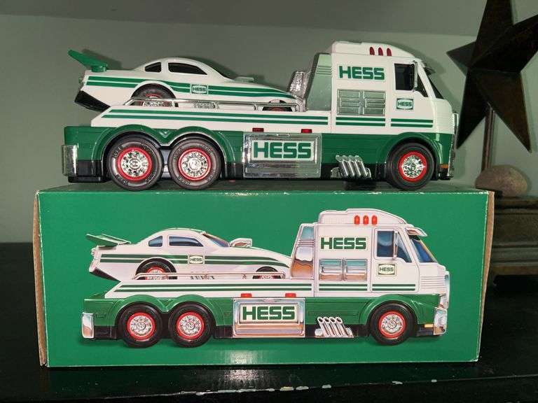 HESS Toy Truck and Dragster in like new condition and in original box…..there are batteries in the box…..makes racing sounds, LED lights, pops wheelies image