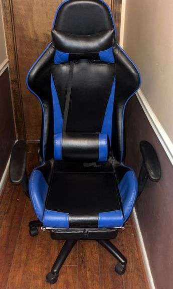 Blue and black rolling high back racing gaming chair, adjustable with foot rest.