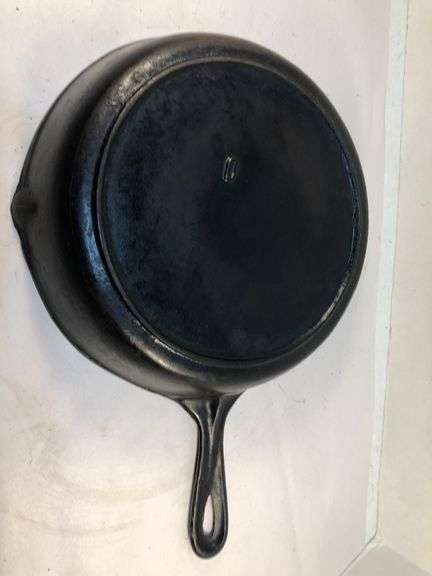 Vi tage cast iron skillet with heat ring. Raised 8 on the front of handle. Ridge on the back ending in a triagular shape in pan side. 0 on back. No spin, no wobble.
