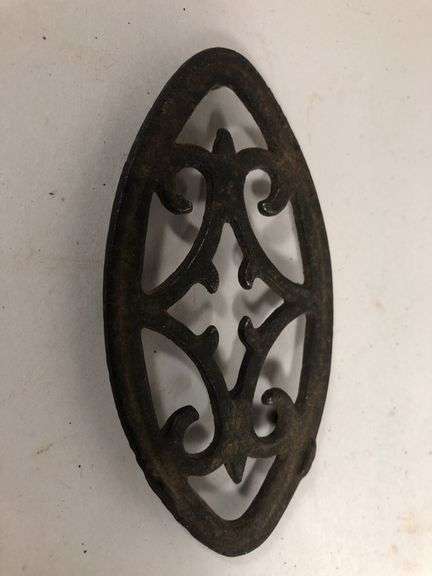Antique child SAD iron footed trivet. Black. 3.5 x 2”