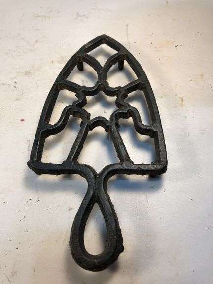 Vintage black, footed cast iron trivet. 7 x 3.5”