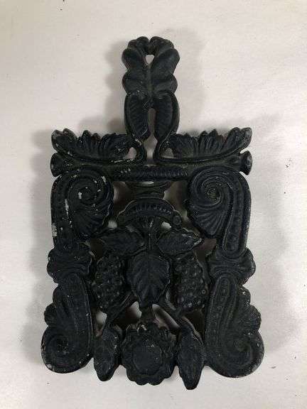 Vintage Wilton #9 grape and vine design scroll trivet, footed. Black finish. 7.25 x 4.25”.