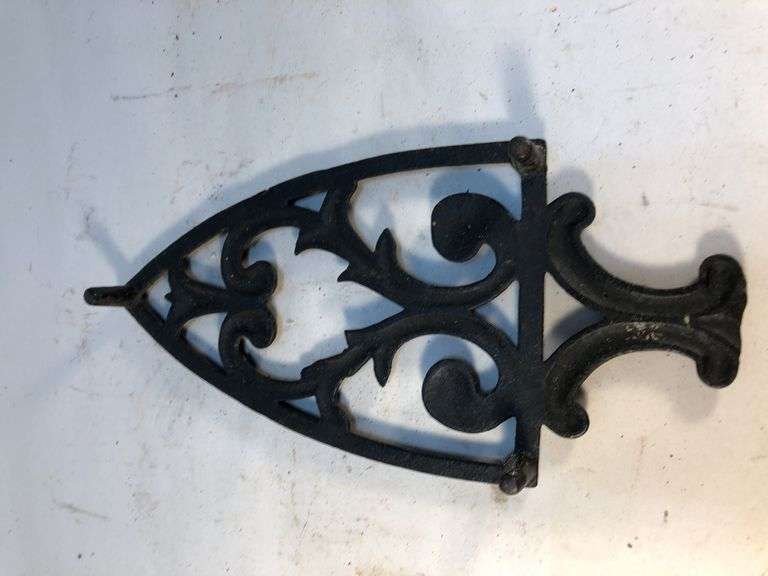 Vintage black, footed cast iron trivet. 8 x 3.75”