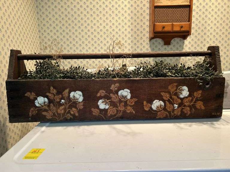 Vintage wooden tool box painted with cotton bolls and filled with artificial greenery image