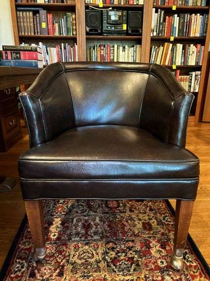 Barrel back leather office chair on casters…..sows wear from normal use but lots of life left…..sits and rolls very well….25 x 18 x 29-3/4 tall overall