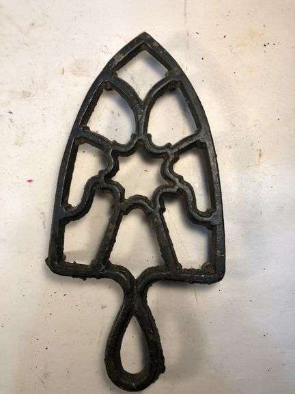 Vintage black, footed cast iron trivet. 7 x 3.5”