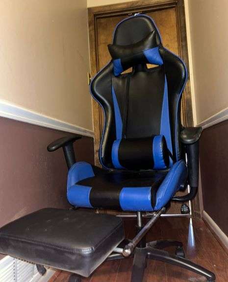 Blue and black rolling high back racing gaming chair, adjustable with foot rest.