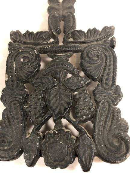 Vintage Wilton #9 grape and vine design scroll trivet, footed. Black finish. 7.25 x 4.25”.