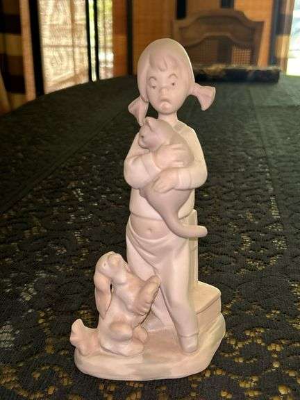 Bisque Porcelain Figurine of girl holding cat with posing dog at her feet…..only marking is Made in Spain and info regarding year received…..8-1/2” tall image