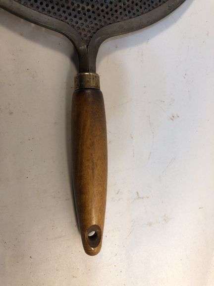 Antique stovetop heat diffuser, also known as a simmer plate or flame fanner with wooden handle, 14 L. 8 1/4” diameter.