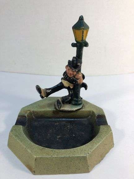 Vintage John Wright cast iron ash tray. Drunk man hanging on lamp post. 4 3/8” W x 4 3/8” D x 5” H. image