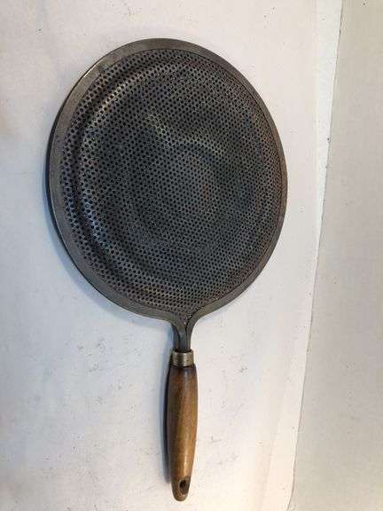 Antique stovetop heat diffuser, also known as a simmer plate or flame fanner with wooden handle, 14 L. 8 1/4” diameter.