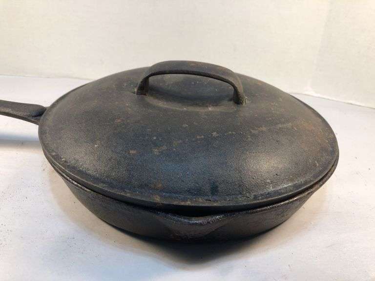 Vintage cast iron skillet with lid. 2 spout. 10” diameter. No spin, no wobble. No markings except an A in the lid.