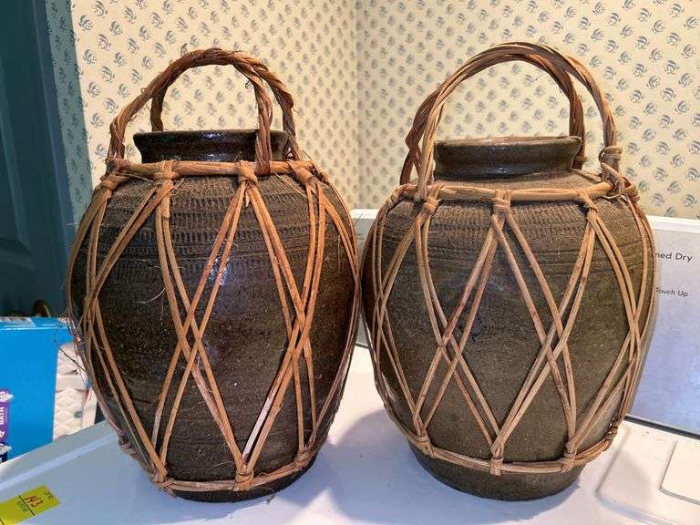 Pair of decorative water vessels encased in rattan…..11” tall image