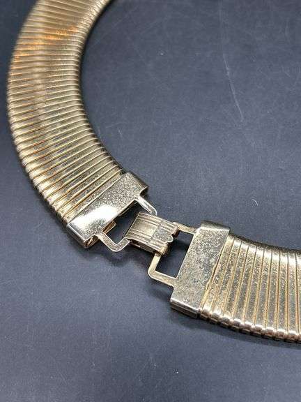 Gold tone choker with rows of clear stones…..clasp needs adjusted and tightened