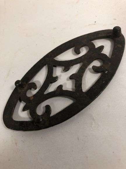 Antique child SAD iron footed trivet. Black. 3.5 x 2”