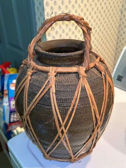 Pair of decorative water vessels encased in rattan…..11” tall