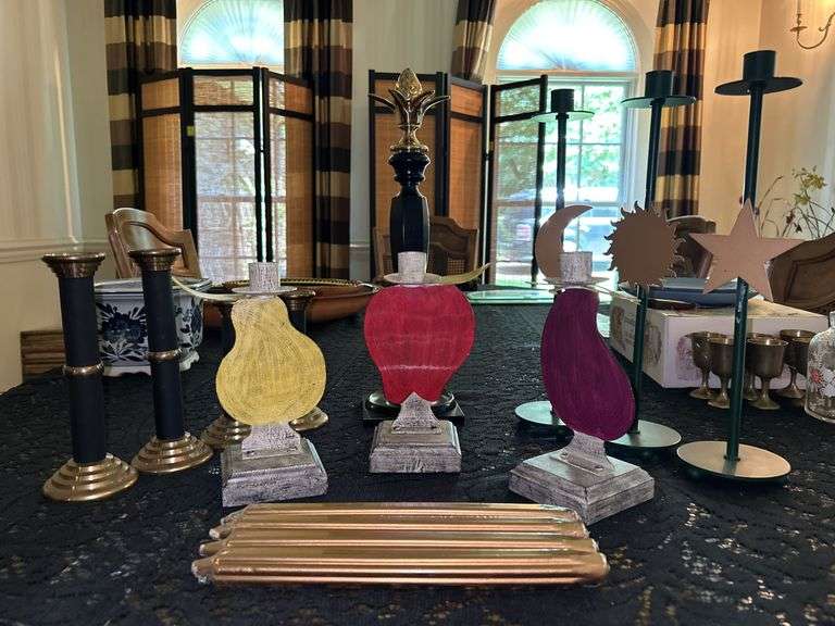Grouping of various size and style candlesticks…..from 6 to 16” tall….some have brass image
