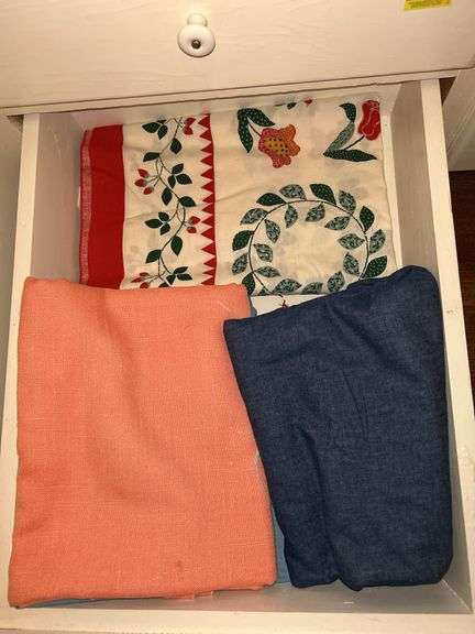 Drawer containing table linens in various sizes…..linen, plastic image