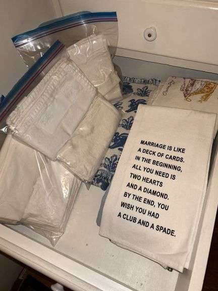 Drawer containing decorative towels, napkins and table linens image