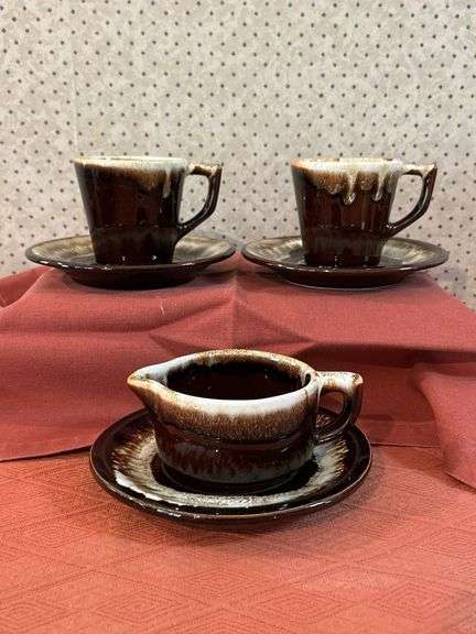 (6) pieces of brown drip glaze stoneware….saucers are unmarked, cups and creamer are Pfaltzgraff image