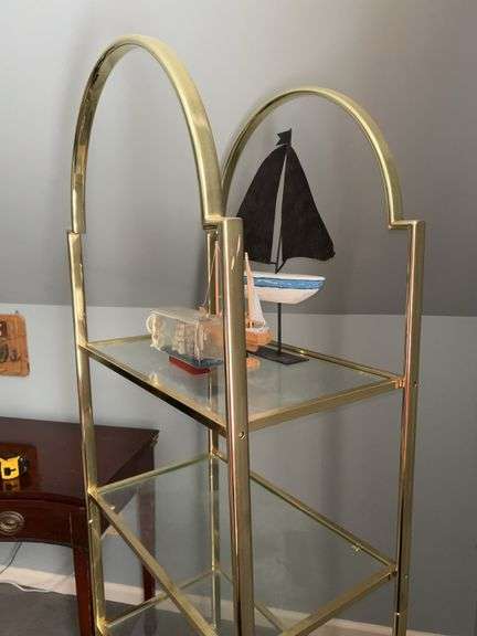 Gold-tone metal shelving unit with 4 glass shelves…..24-1/2 x 14-1/4 x 67-1/2 tall…..OTHER CONTENTS NOT INCLUDED