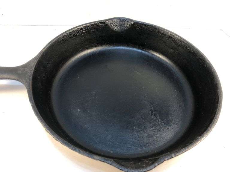 Unmarked #8  10” diameter 2 spout skillet. No spin, no wobble.