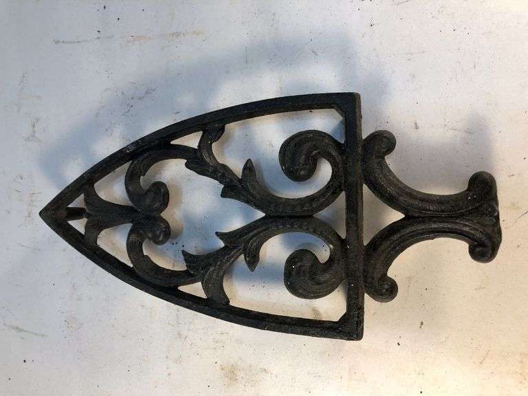 Vintage black, footed cast iron trivet. 8 x 3.75”