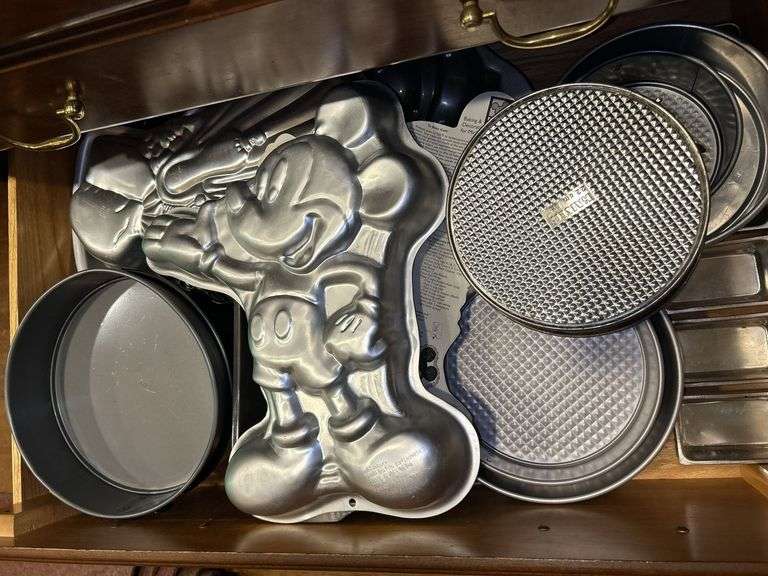 Kitchen drawer full of various size and design bakeware pans image