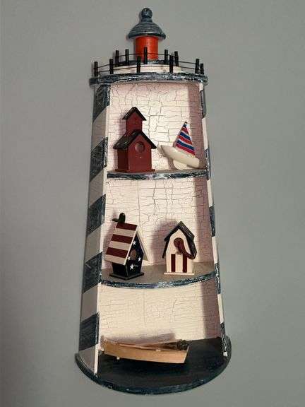 Very cute lake house decor…..lighthouse shelf with small decor items image