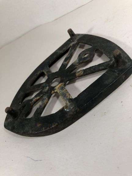 Antique cast iron trivet, specifically designed as a rest for a "sad iron" or "flat iron". 6 x 4.5”