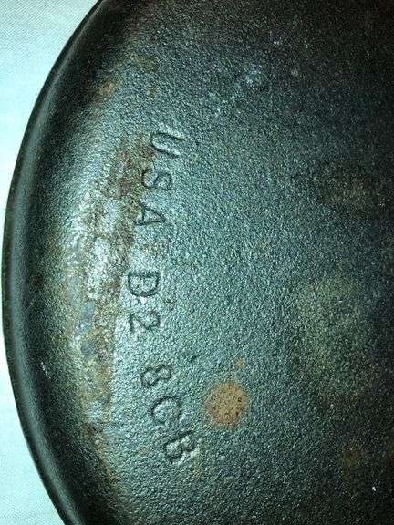 Lodge 9” diameter cornbread skillet.  USA D2 8CB
