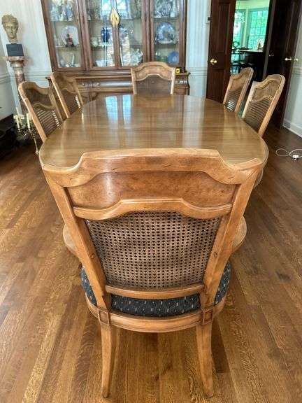 Very nice double pedestal maple(?) dining table with (4) side chairs and (2) captains chairs with faux cane backs…..comes with table pads (have been repaired and well used) and beautiful black lace overlay….there are minor blemishes from normal use image