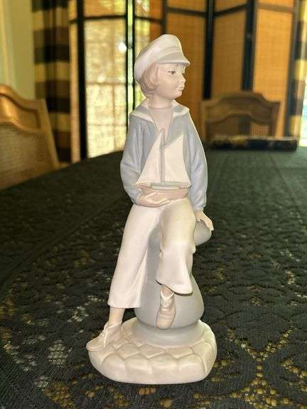LLADRO Boy Sailor with Sailboat Bisque Porcelain Figurine (#4810)…..9” tall….there are initials and date on bottom image