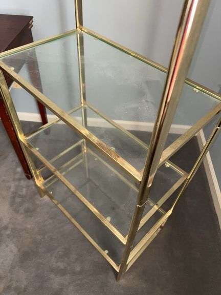Gold-tone metal shelving unit with 4 glass shelves…..24-1/2 x 14-1/4 x 67-1/2 tall…..OTHER CONTENTS NOT INCLUDED