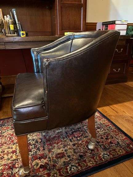 Barrel back leather office chair on casters…..sows wear from normal use but lots of life left…..sits and rolls very well….25 x 18 x 29-3/4 tall overall