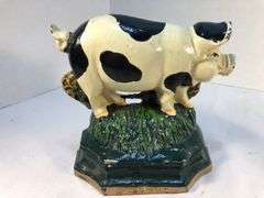 Vintage pair of cast iron black and white spotted pig book ends/door stops. 5 1/2” W x 5” H x 2”D.