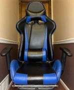Blue and black rolling high back racing gaming chair, adjustable with foot rest.