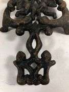 Vintage Wilton cast iron Cherub trivet. Black. 8 x 4.5”.