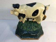 Vintage pair of cast iron black and white spotted pig book ends/door stops. 5 1/2” W x 5” H x 2”D.